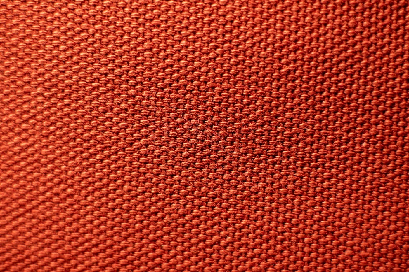 Close-up of a red coated woven fabric